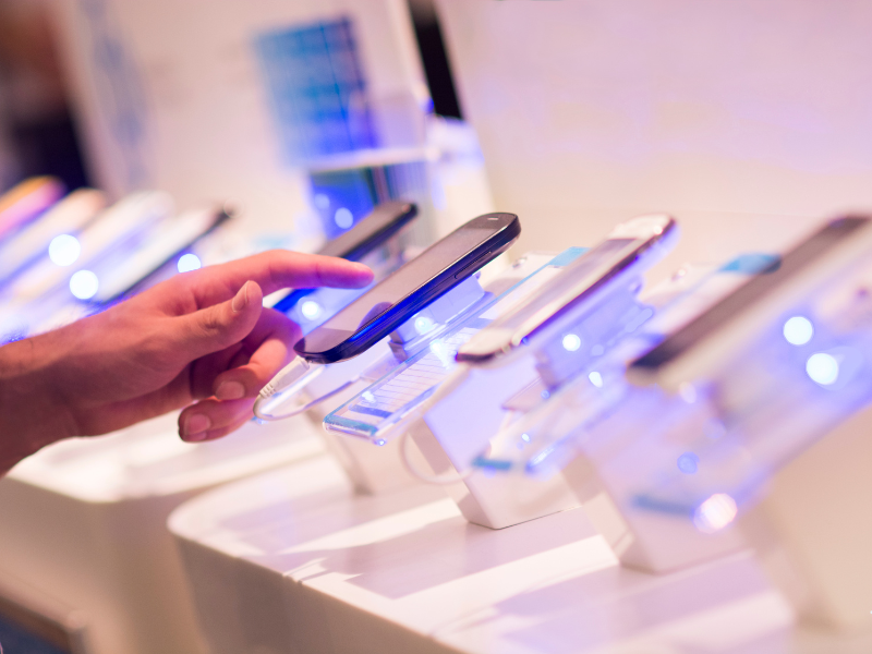 a person trying a cell phone at a store