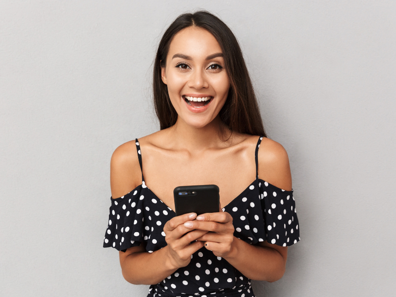 Woman Smiling Holding A Phone